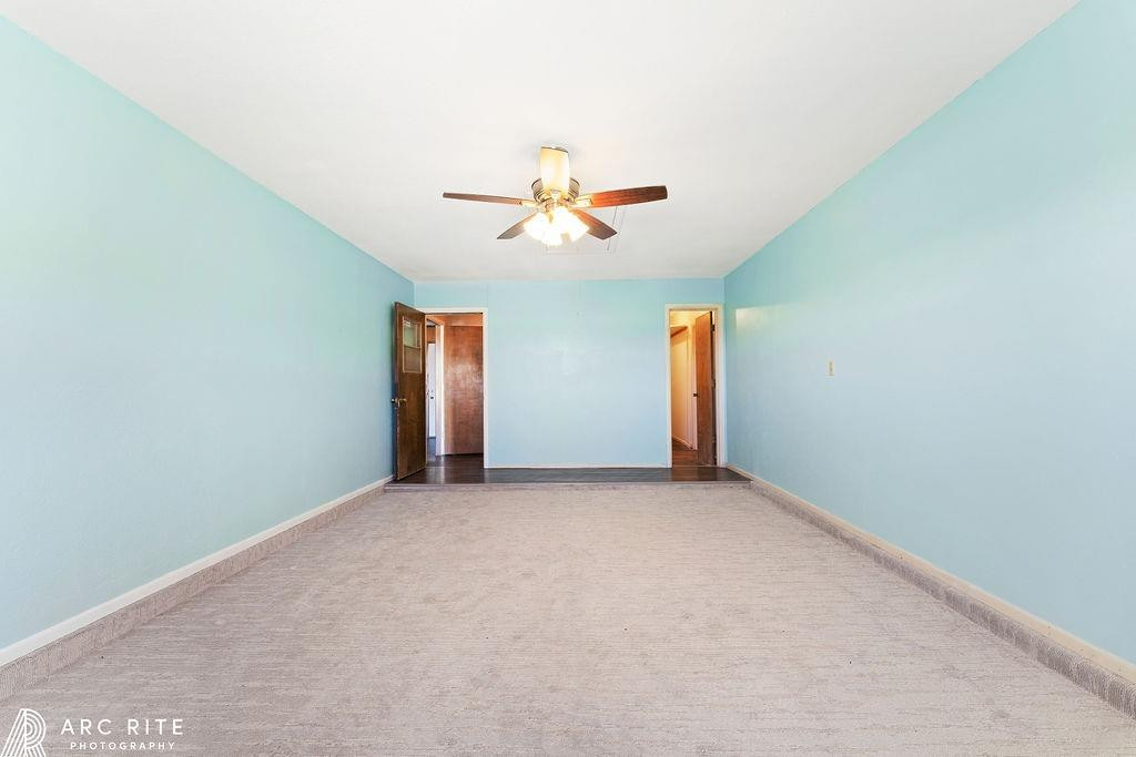 2123 North Cypress Road Lubbock, TX 79403 - Photo 18 of 22 an empty room with closet and a ceiling fan