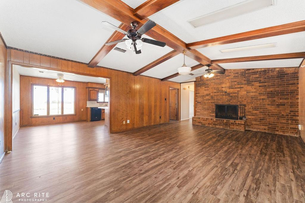 2123 North Cypress Road Lubbock, TX 79403 - Photo 2 of 22 a view of empty room with wooden floor and fireplace