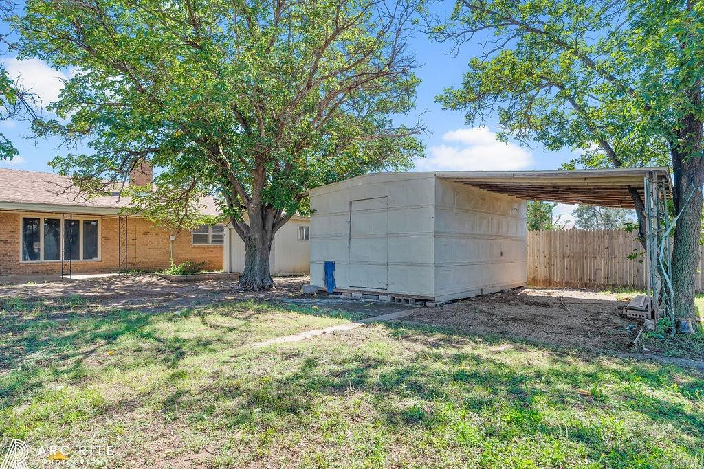 2123 North Cypress Road Lubbock, TX 79403 - Photo 21 of 22 a view of a backyard with a tree