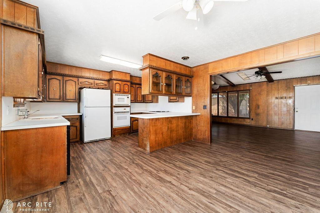 2123 North Cypress Road Lubbock, TX 79403 - Photo 7 of 22 a kitchen with stainless steel appliances wooden floor and a refrigerator