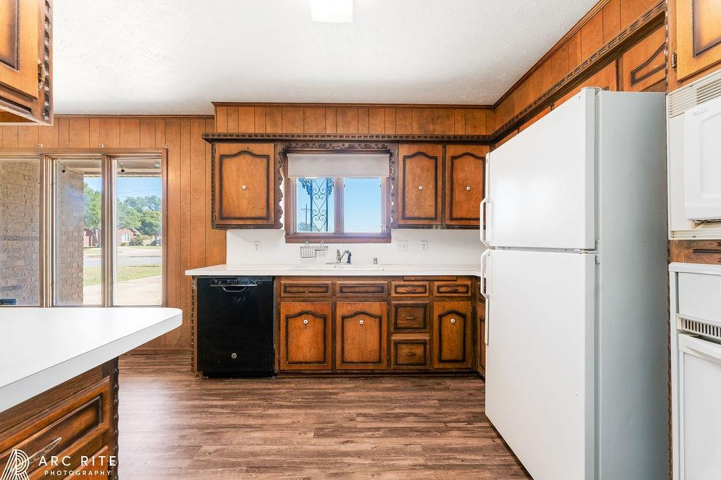 2123 North Cypress Road Lubbock, TX 79403 - Photo 9 of 22 a kitchen with stainless steel appliances granite countertop a refrigerator a stove and a sink with wooden cabinets