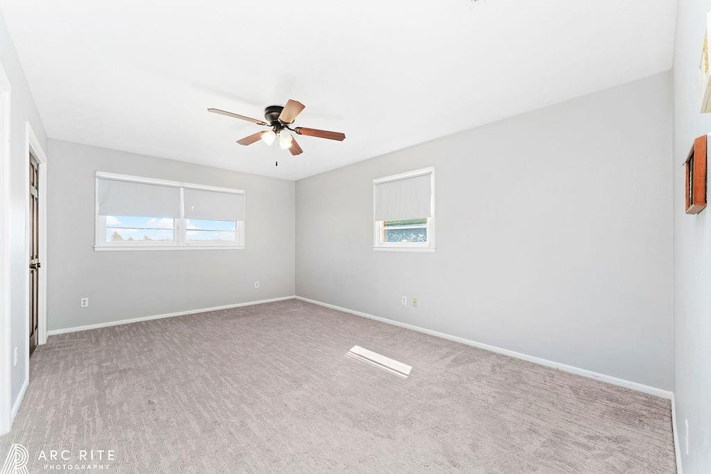 2123 North Cypress Road Lubbock, TX 79403 - Photo 10 of 22 wooden floor in an empty room with a window