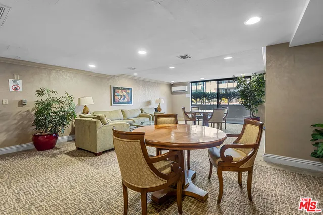 a dining room with furniture and potted plants