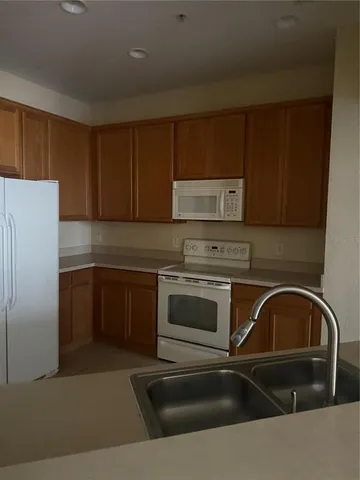 a kitchen with a sink a stove and cabinets