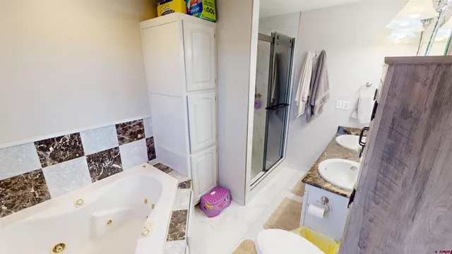 a bathroom with a sink toilet and shower