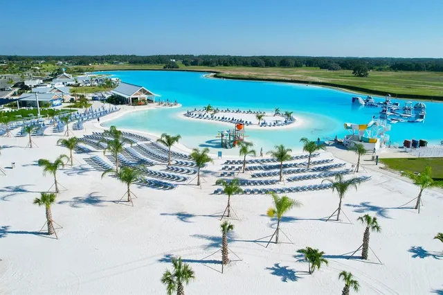 a childrens park with lots of swings and slides and swimming pool