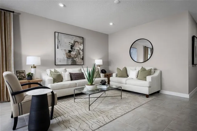 a living room with furniture a flat screen tv and a large window
