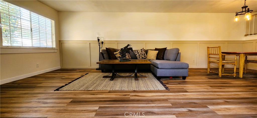 10032 Base Line Road Rancho Cucamonga, CA 91701 - Photo 1 of 1 a living room with furniture and a floor to ceiling window
