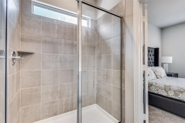 a bathroom with a shower and a sink