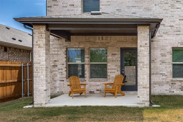 a view of a patio with a table and chairs