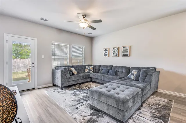 a living room with furniture and a large window