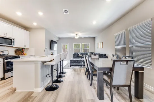 a view of kitchen with cabinets table and chairs