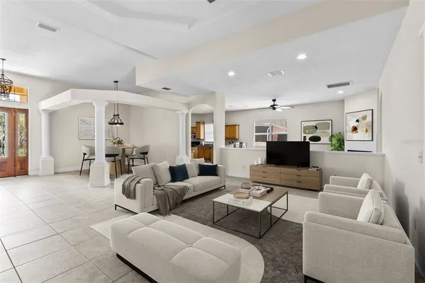 a living room with furniture and a view of kitchen