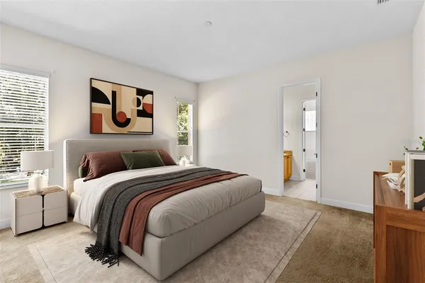 a bedroom with a bed and a couch