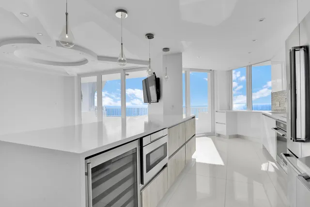 a kitchen with white cabinets and appliances