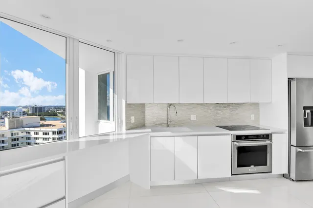 a kitchen that has a sink and a stove in it