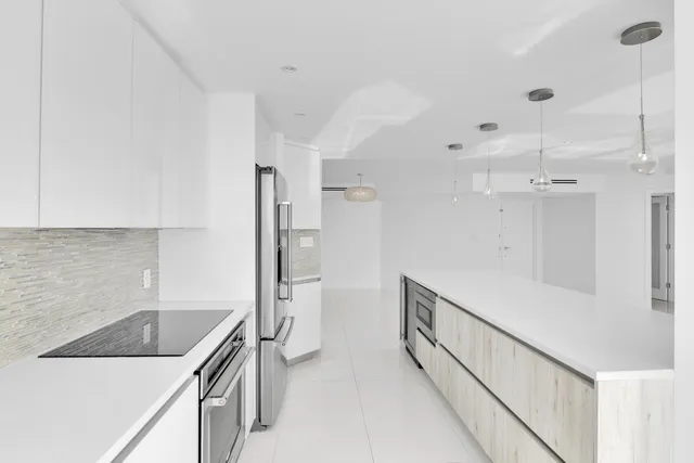 a kitchen with stainless steel appliances a refrigerator sink and microwave