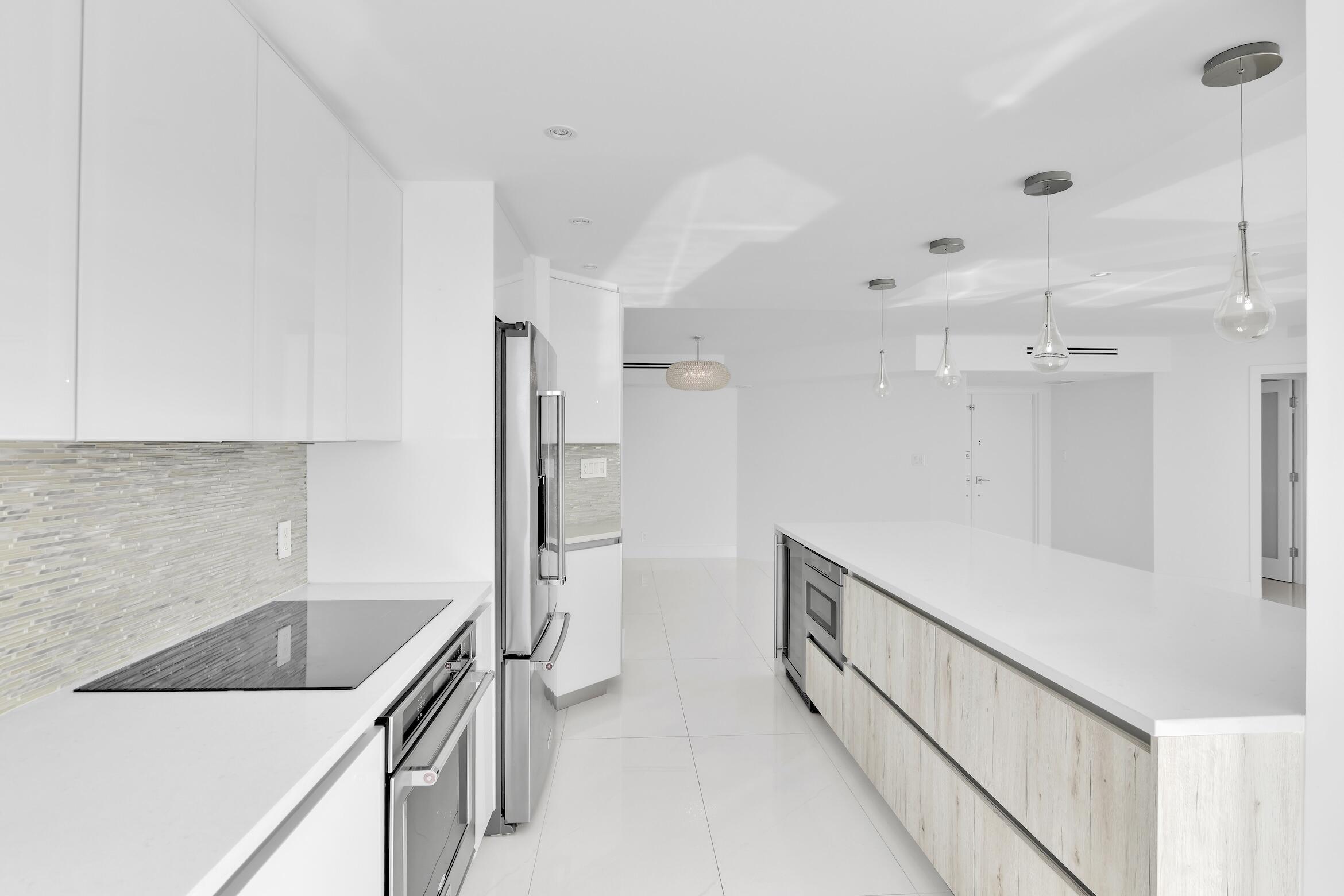 550 South Ocean Boulevard, Unit PH06 Boca Raton, FL 33432 - Photo 15 of 62 a kitchen that has a sink and a stove in it