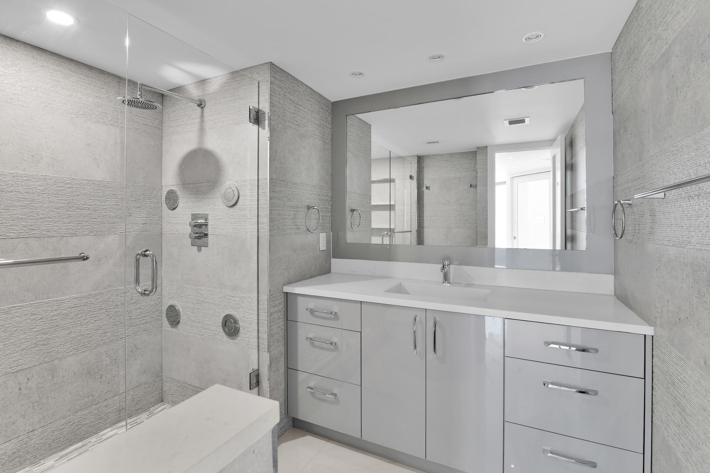 550 South Ocean Boulevard, Unit PH06 Boca Raton, FL 33432 - Photo 21 of 62 a spacious bathroom with a granite countertop sink mirror and shower