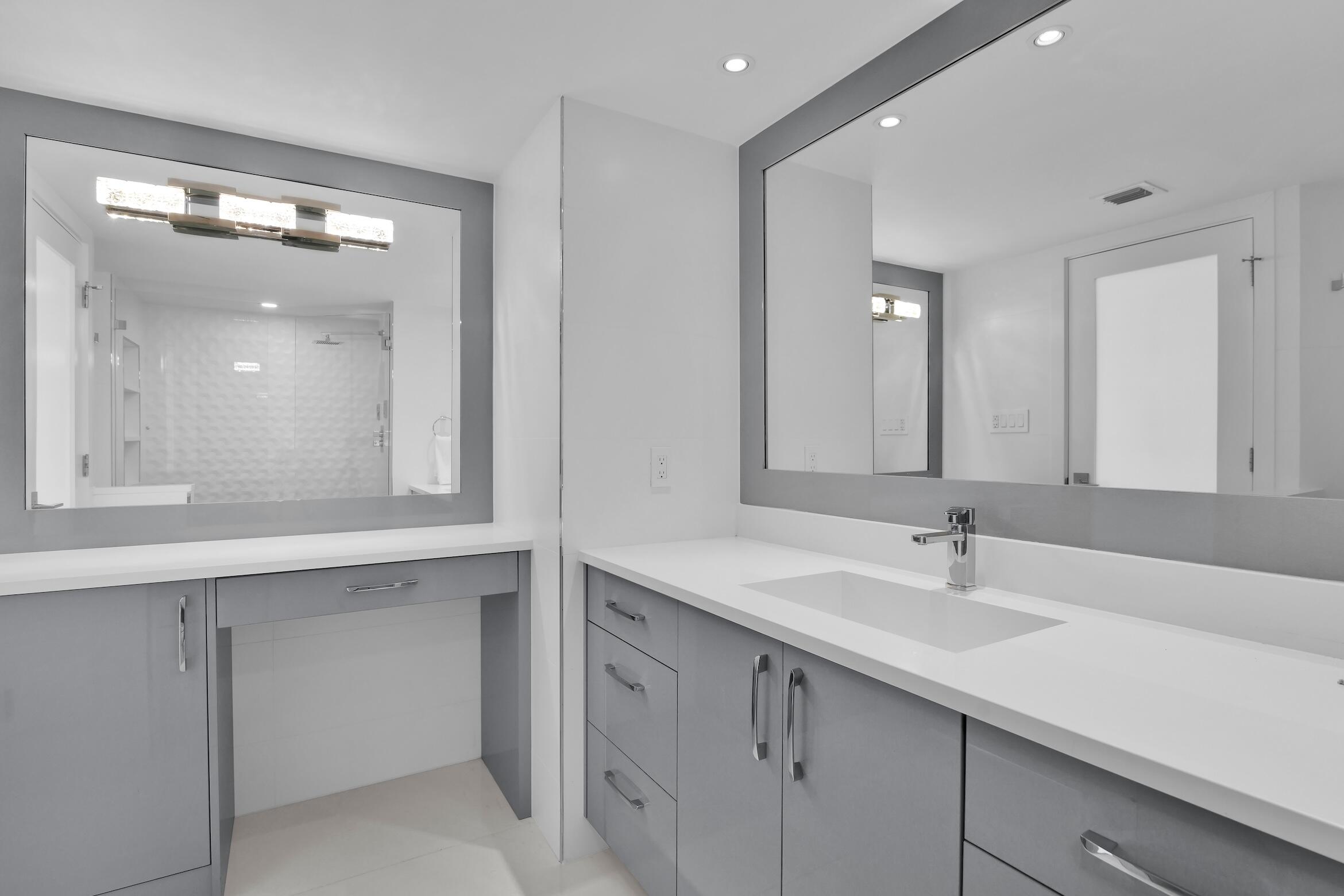 550 South Ocean Boulevard, Unit PH06 Boca Raton, FL 33432 - Photo 23 of 62 a bathroom with a double vanity sink mirror and