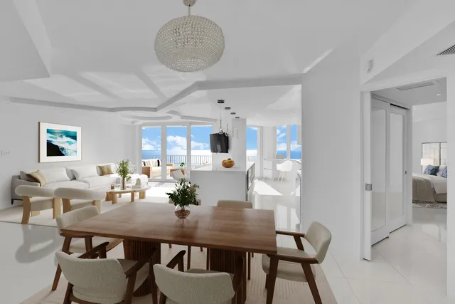 a living room with furniture and kitchen view