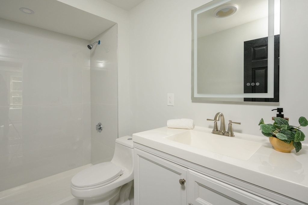 120 Broadway Hanover, MA 02339 - Photo 14 of 35 a bathroom with a sink a toilet and shower