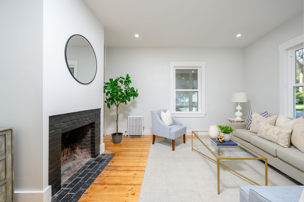 120 Broadway Hanover, MA 02339 - Photo 18 of 35 a living room with furniture a window and a fireplace