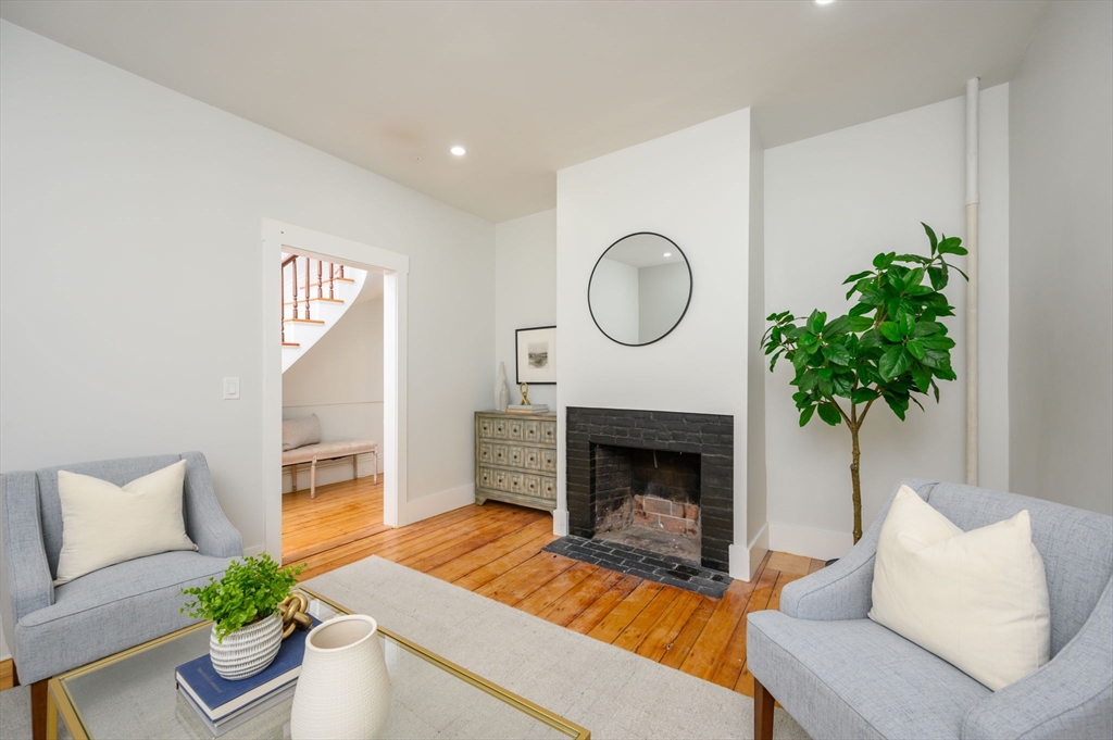 120 Broadway Hanover, MA 02339 - Photo 20 of 35 a living room with furniture and a fireplace