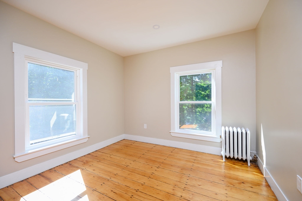120 Broadway Hanover, MA 02339 - Photo 25 of 35 a view of an empty room with wooden floor and a window