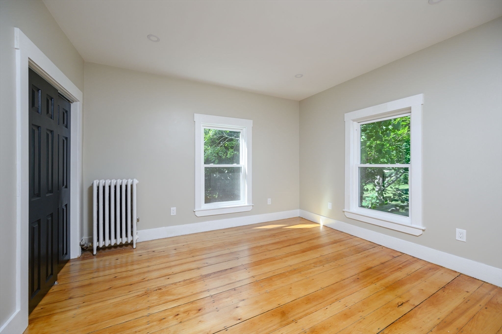 120 Broadway Hanover, MA 02339 - Photo 29 of 35 a view of an empty room with wooden floor and a window