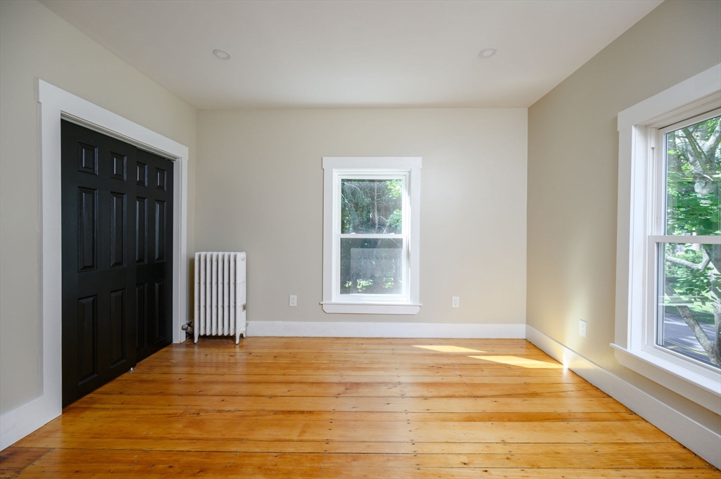 120 Broadway Hanover, MA 02339 - Photo 30 of 35 a view of an empty room with wooden floor and a window