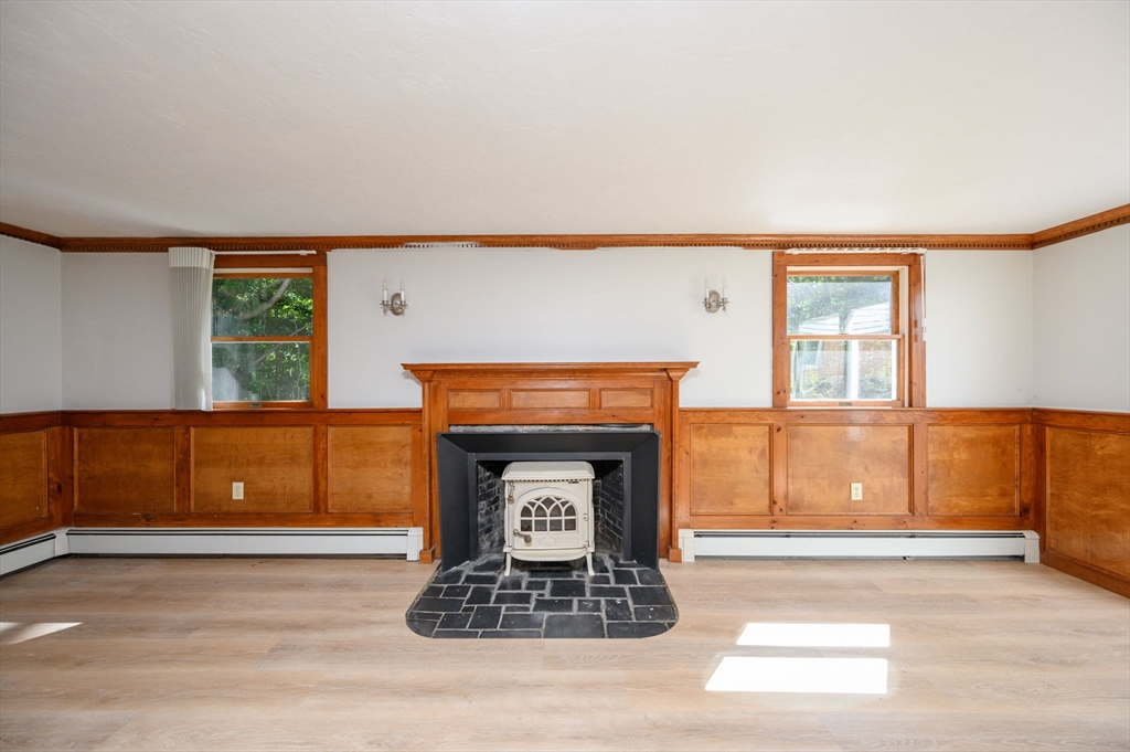 120 Broadway Hanover, MA 02339 - Photo 34 of 35 a living room with a fireplace and a window