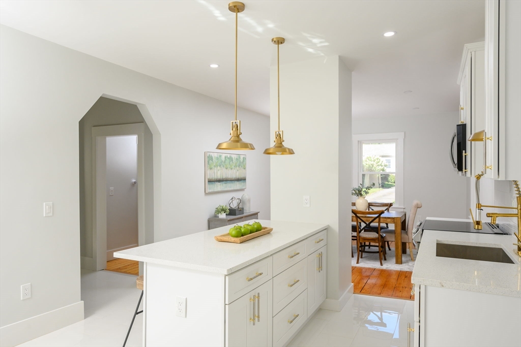 120 Broadway Hanover, MA 02339 - Photo 5 of 35 a view of kitchen and dining area with chandelier