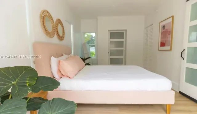 a bedroom with a bed dresser and a window