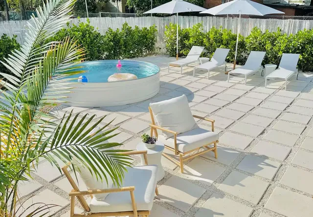 a view of a patio with chairs and plants