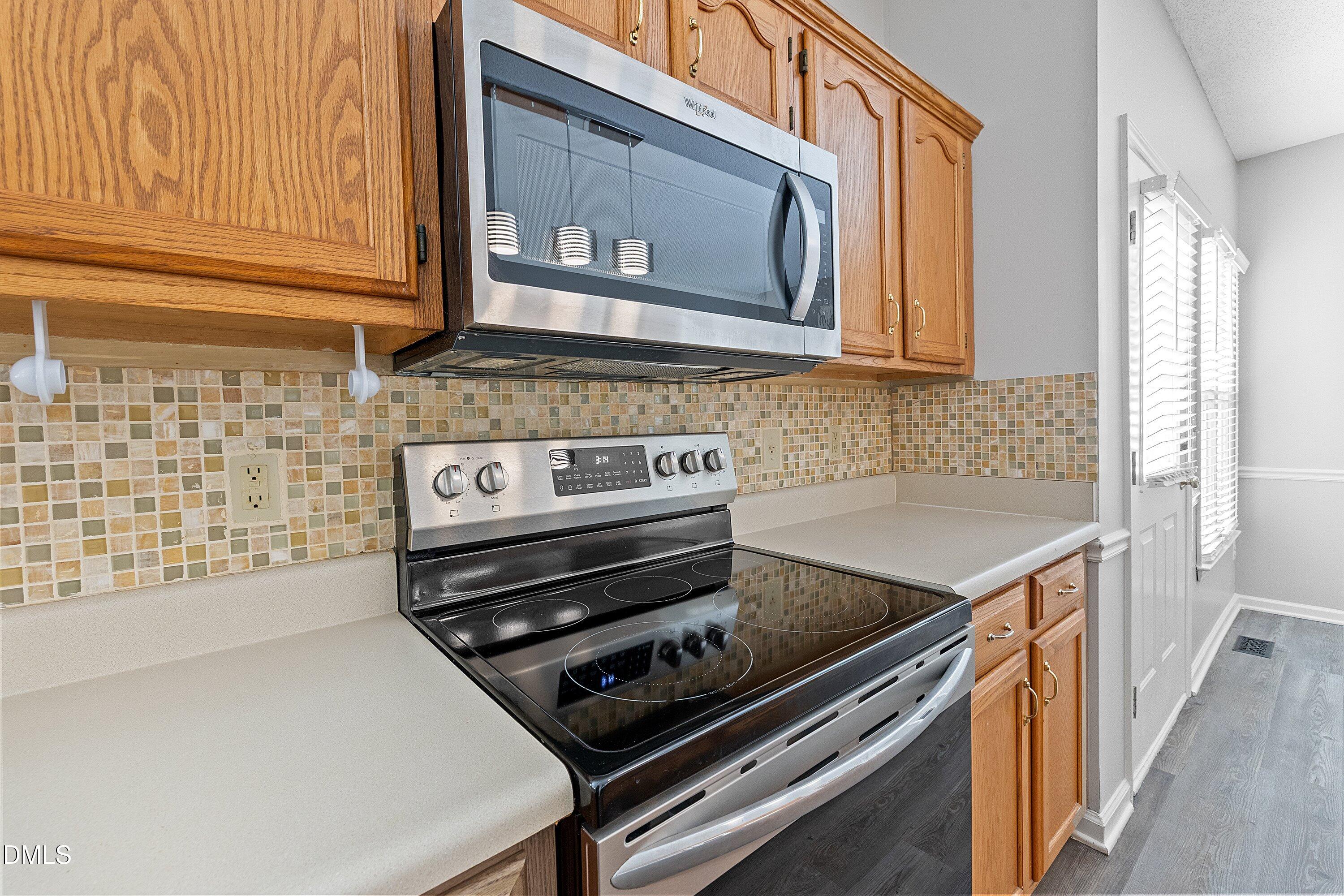 113 Laurel Branch Drive Cary, NC 27513 - Photo 18 of 40 a kitchen with a stove and white cabinets
