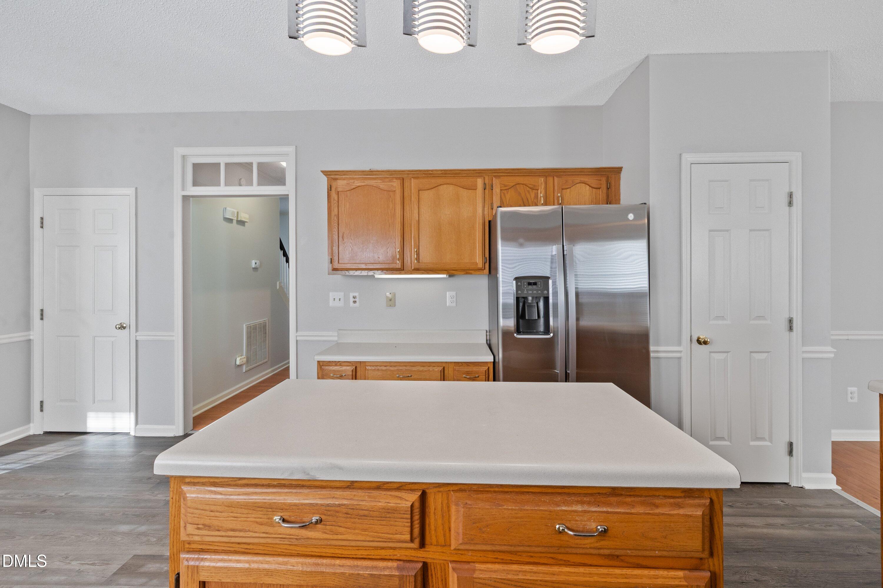 113 Laurel Branch Drive Cary, NC 27513 - Photo 20 of 40 a room with a refrigerator and wooden floor