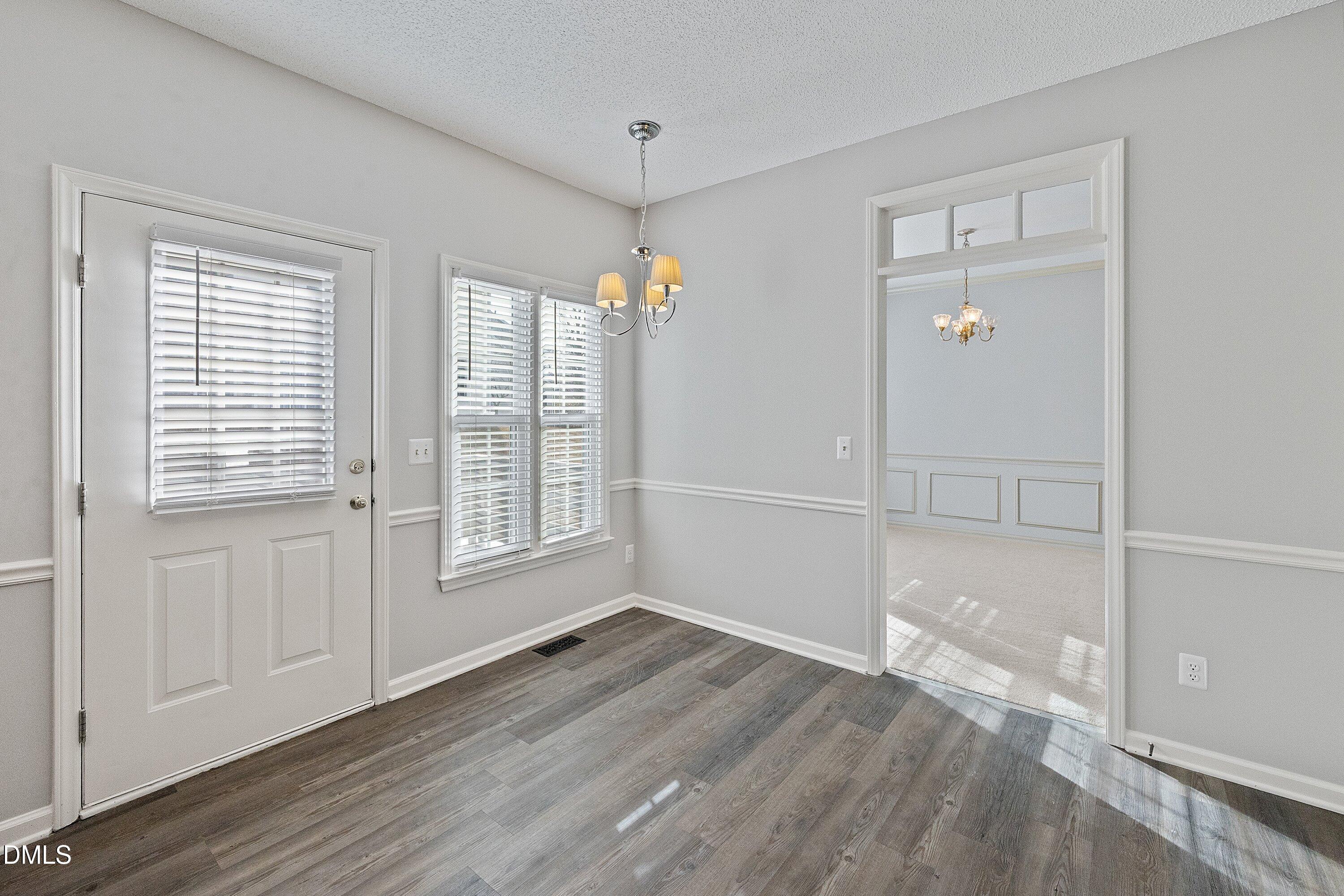 113 Laurel Branch Drive Cary, NC 27513 - Photo 21 of 40 a view of an empty room with wooden floor and a window