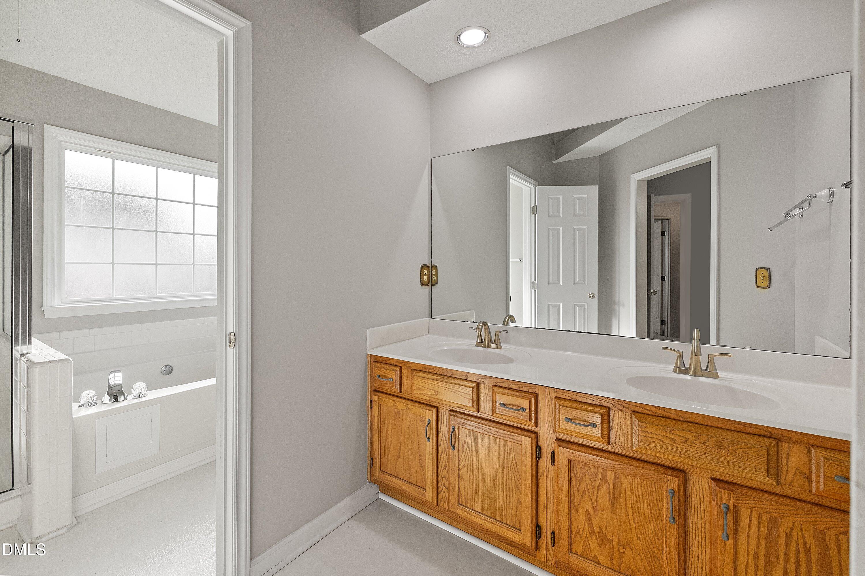 113 Laurel Branch Drive Cary, NC 27513 - Photo 28 of 40 a bathroom with a granite countertop sink and a mirror