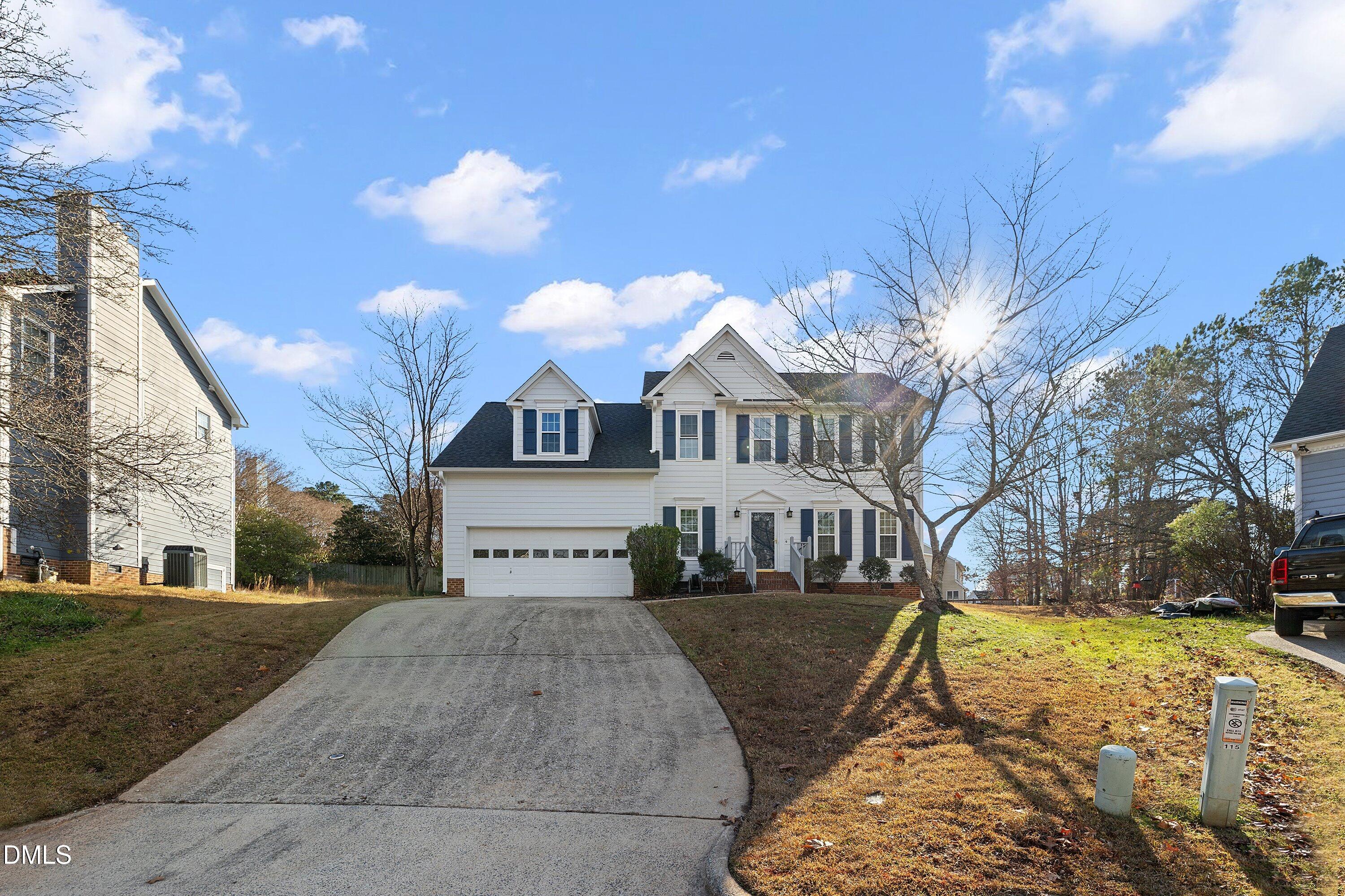 113 Laurel Branch Drive Cary, NC 27513 - Photo 2 of 40 a view of a white house with a yard covered in snow