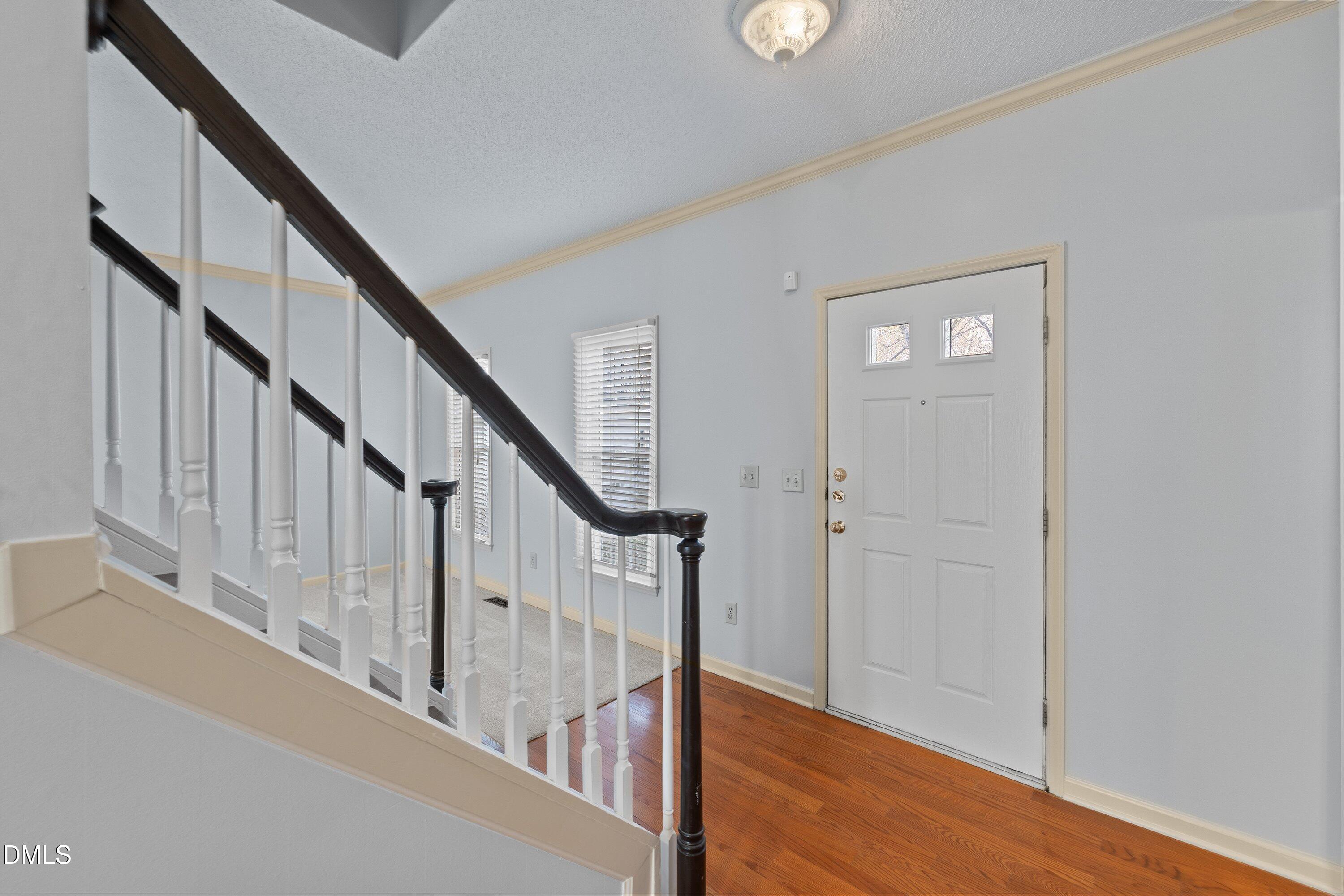 113 Laurel Branch Drive Cary, NC 27513 - Photo 6 of 40 a view of staircase with wooden floor and white walls