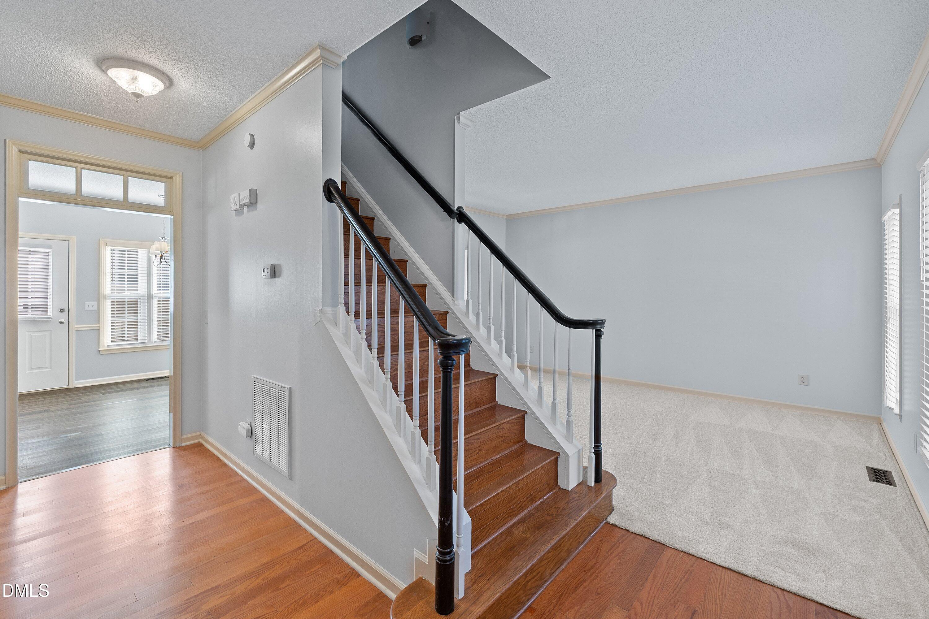 113 Laurel Branch Drive Cary, NC 27513 - Photo 7 of 40 a view of staircase with wooden floor and fan