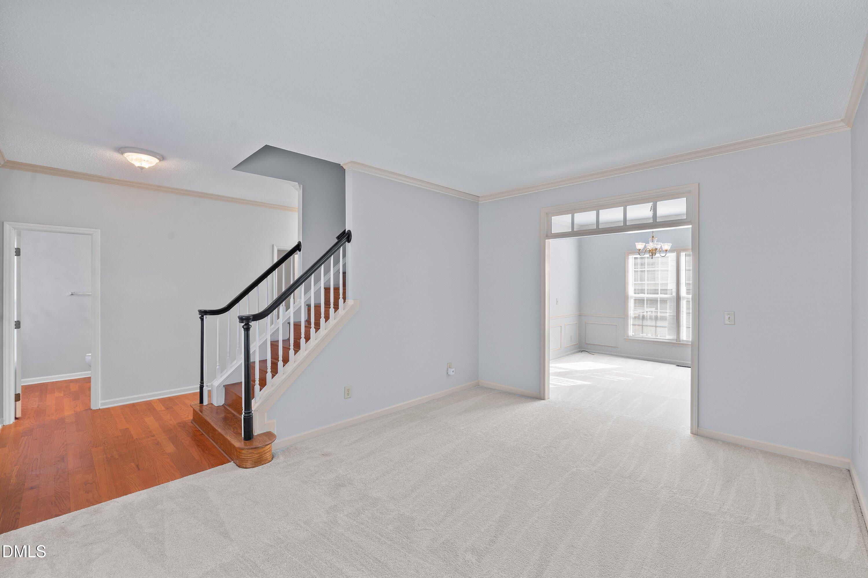 113 Laurel Branch Drive Cary, NC 27513 - Photo 9 of 40 a view of an empty room with stairs and a couch