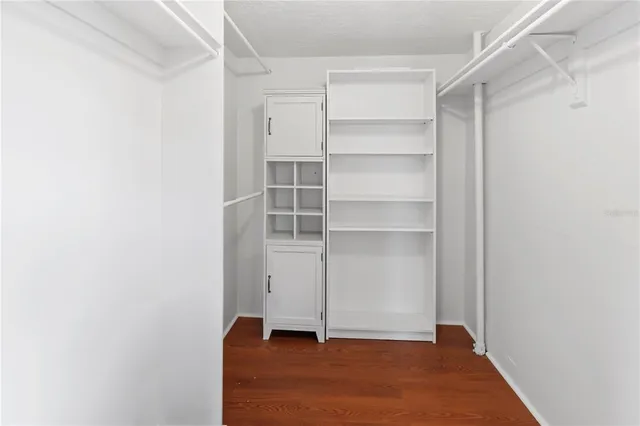 a bathroom with a sink shower and a mirror