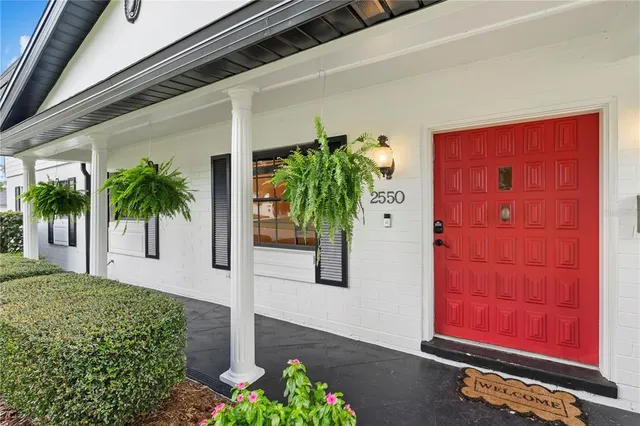 a view of a patio with table and chairs potted plants