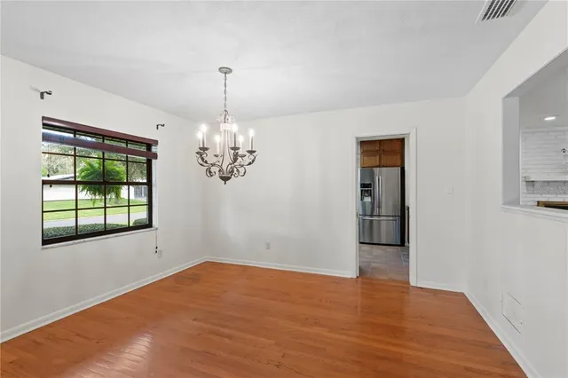 a kitchen with a sink window and cabinets