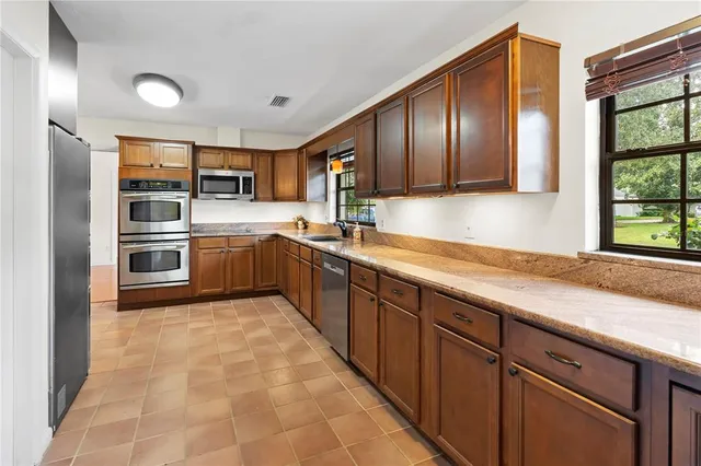 a view of an empty room with a fireplace and a window