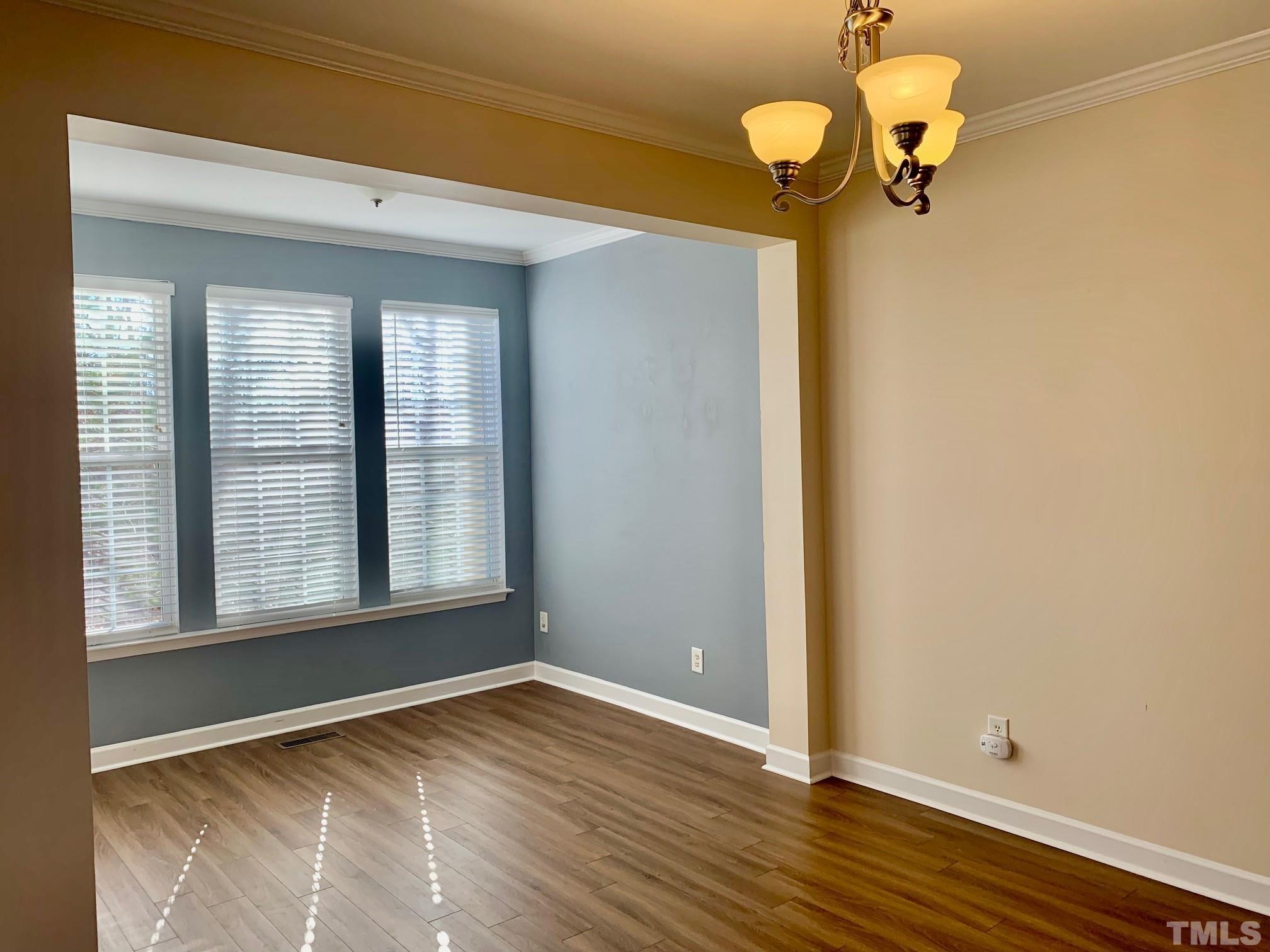 241 Grenoch Valley Lane Apex, NC 27539 - Photo 11 of 27 a view of a room with wooden floor fan and window