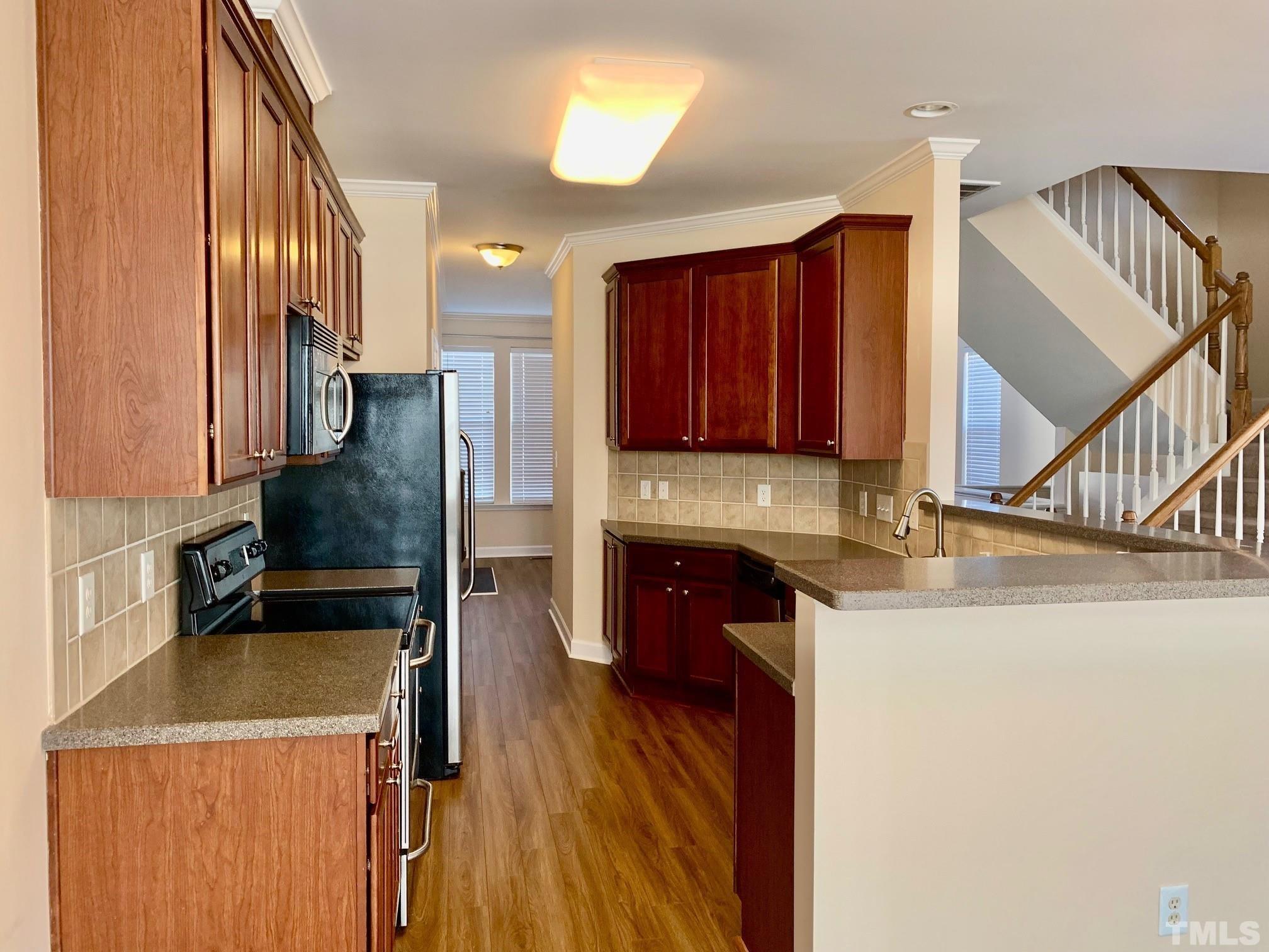 241 Grenoch Valley Lane Apex, NC 27539 - Photo 13 of 27 a kitchen with stainless steel appliances granite countertop a refrigerator a stove top oven a sink and dishwasher