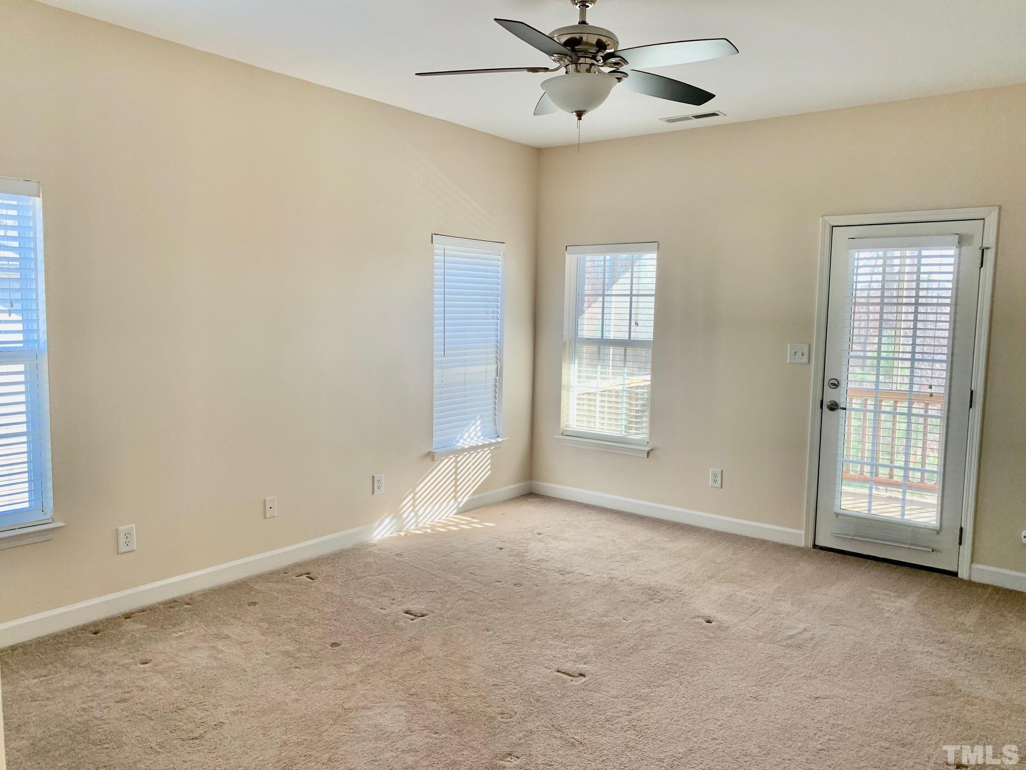 241 Grenoch Valley Lane Apex, NC 27539 - Photo 17 of 27 an empty room with windows and fan